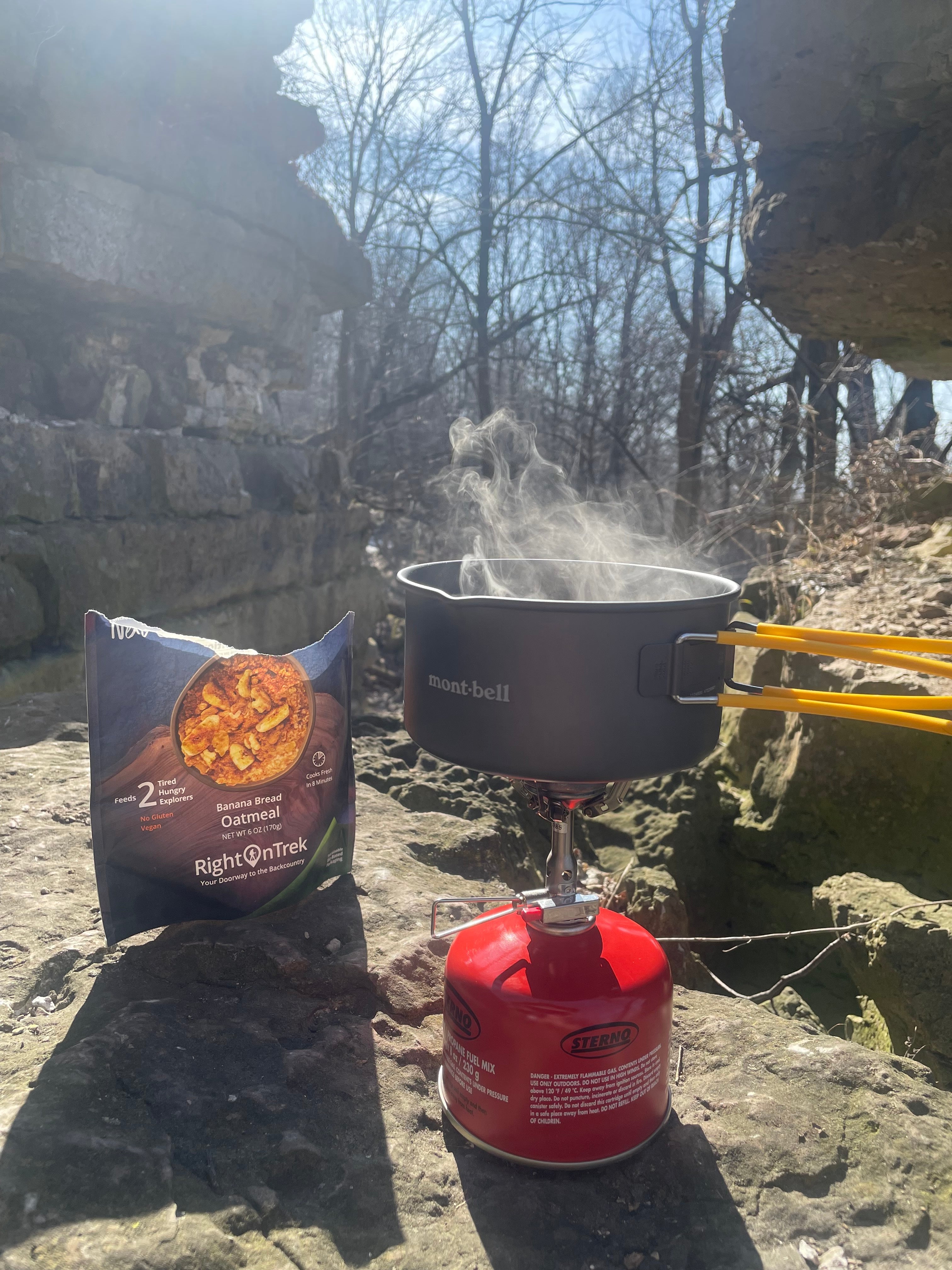 Backcountry meal being cooking in a pot in the woods